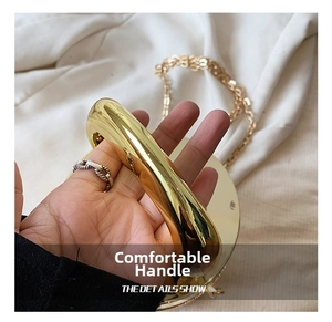Detail view of the elegant golden metal handle and fine chain strap on the acrylic box bag
