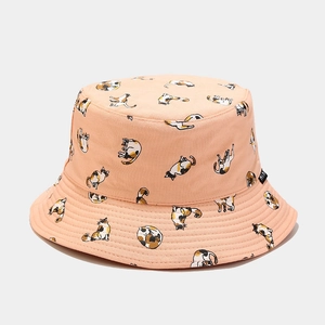 Close-up of beige cotton bucket hat featuring cute calico cat prints and logo tag