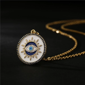 Gold plated white evil eye pendant necklace with blue and clear zircon crystals