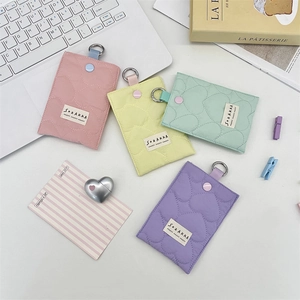 Flat lay of colorful quilted heart pattern card holders with metallic ring clips