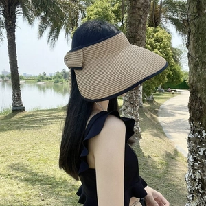 Women's summer straw sun visor with wide brim and black trim for outdoor beach protection