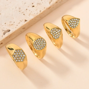 Detail of four gold rings with crystal heart, hexagon, round, and triangle settings