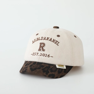 Detail of embroidered letters and leopard print brim on children baseball cap