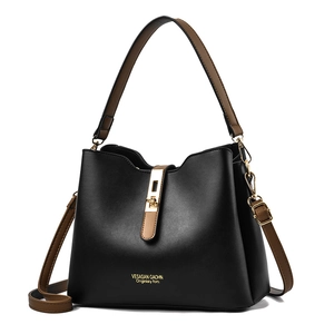 Chic black leather handbag with brown straps and gold hardware, 2025 fashion collection
