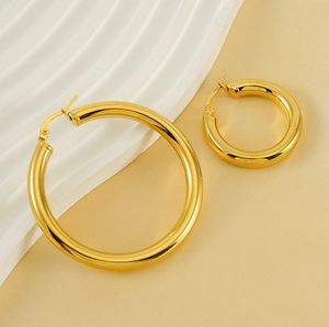 Detailed view of two sizes of polished 18K gold-plated titanium steel hoop earrings