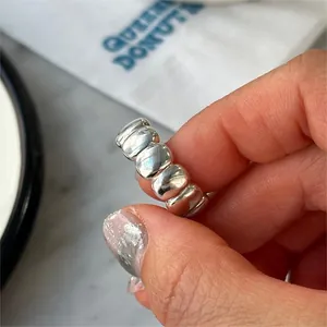 Detailed close-up of a high-polished S925 silver oval ring with minimalist design