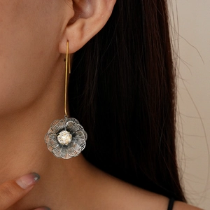 Macro shot of 18K gold-plated double-layer hollow flower earring with sparkling zircon