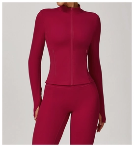 Detail of burgundy slim fit yoga jacket with thumbholes and invisible zipper pockets