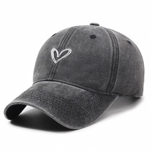Washed dark grey baseball cap with white heart embroidery in a professional 45-degree view