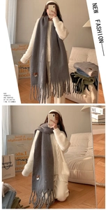 Detailed knit texture and fringe design of gray soft cashmere-feel winter scarf