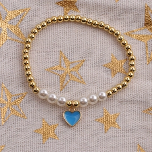 Detail of beaded bracelet with gold metal beads, white pearls and blue heart charm