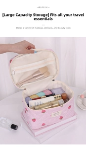 Detail of strawberry quilted makeup bag featuring large interior capacity and mesh pocket