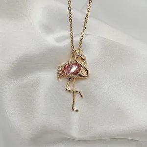 Macro shot of flamingo pendant featuring a pink pear-cut stone and pavé zircon details