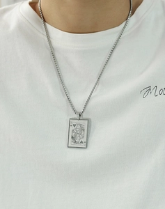 Detailed view of stainless steel King of Hearts poker card pendant on a square link chain