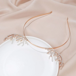 Detailed close-up of rose gold reindeer antler headband with sparkling white rhinestones