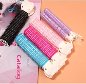 Macro shot of colorful hair rollers with clips for bangs and volume in five vibrant colors