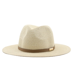 Detail of light beige straw fedora hat featuring a brown leather band and gold metal buckle