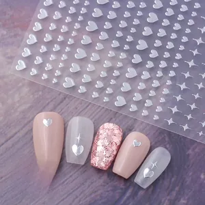 Detail of silver metallic heart and star nail stickers on various polish colors