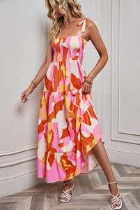 Detail of floral backless sundress featuring tiered skirt and tied shoulder straps