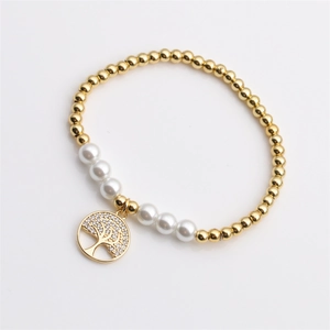Elegant gold-plated beaded bracelet with pearls and a crystal-set Tree of Life charm