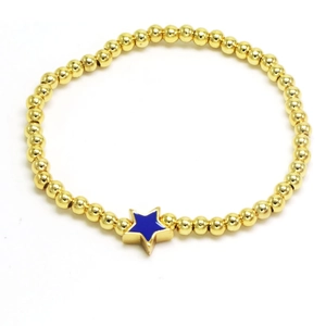 Detailed close-up of a gold beaded bracelet featuring a vibrant blue enamel star charm