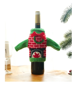 Detailed knit Christmas wine bottle sweater with fireplace pattern and red velvet bow