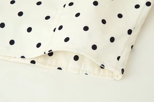 Detail of high-quality stitching and polka dot print fabric on a stand collar jacket