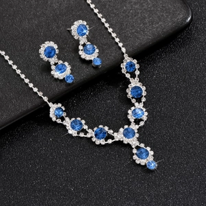 Close-up of sapphire blue and diamond bridal jewelry set with necklace and earrings