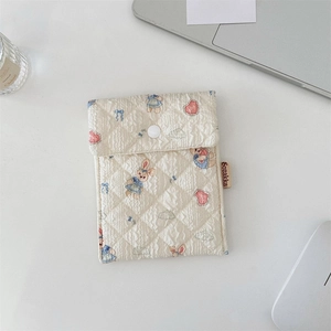 Quilted cotton sanitary bag with bunny and heart print showing button closure