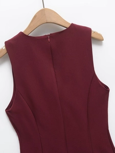 Detailed view of invisible zipper closure on the back of wine red sleeveless dress