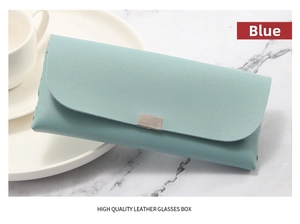 Detail of light blue lychee pattern leather sunglasses case with metal clasp closure