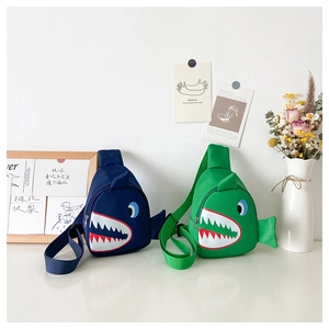 Detail of cartoon shark chest bags for kids in navy and green with adjustable straps