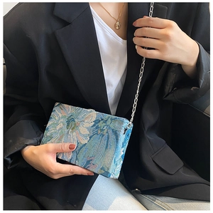 Close-up of floral jacquard mini box bag with elegant silver metal chain strap
