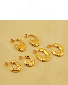 Detailed view of three pairs of 18K gold plated croissant earrings with textured patterns