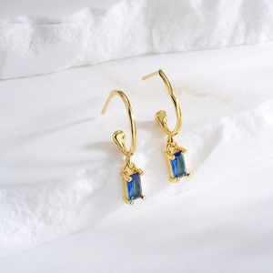 Minimalist gold-plated hoop earrings featuring elegant rectangular blue zircon pendants