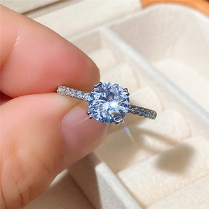Detailed macro view of white gold plated ring with round solitaire zircon and pavé band