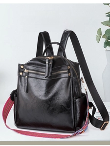 Glossy black PU backpack featuring multiple zip compartments and a colorful woven strap