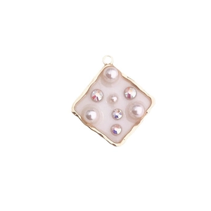 Rhombus enamel pendant with gold alloy edges, faux pearls and rhinestones on white