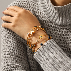 Set of four 18k gold plated stainless steel wire bracelets with evil eye and butterfly charms