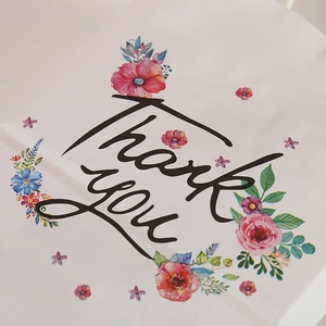 White kraft paper gift bag with floral patterns and Thank You text for birthdays