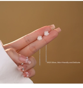 Detail of S925 sterling silver rose drop earrings with delicate tassel chain on hand
