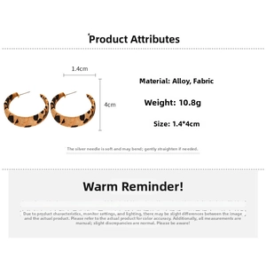 Detailed view of leopard print fabric C-shaped earrings with size and weight specs