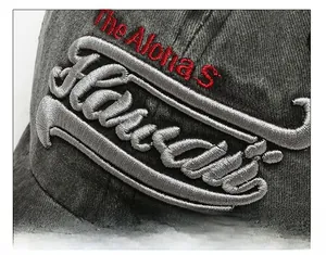 Macro shot of 3D embroidery detail on a vintage washed grey cotton baseball cap