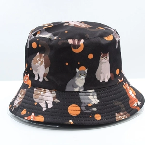 Detail of black reversible bucket hat with all-over cartoon cat and orange dot prints
