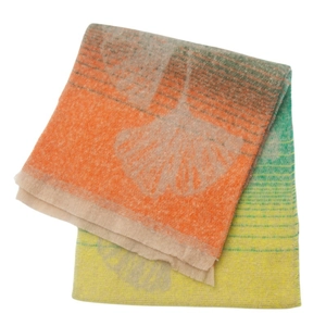 Detail of soft jacquard scarf showing orange and green ginkgo leaf pattern texture