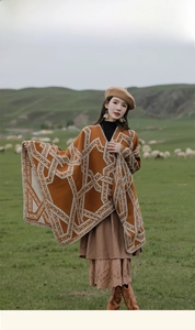 Detail of ethnic style knit poncho shawl with geometric patterns on nature background