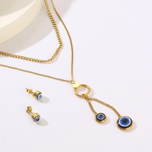 Detail view of golden double-layer evil eye necklace set with matching stud earrings