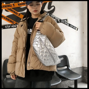 Detail of silver metallic quilted crossbody bag with adjustable wide strap for street style