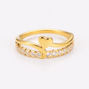 Macro shot of gold double-layer heart ring with cubic zirconia inlay and wavy band