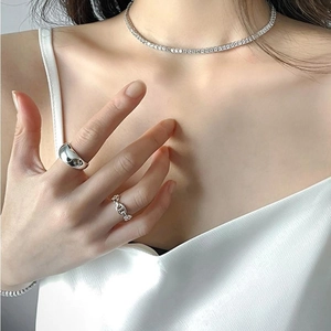 Close-up of minimalist 925 sterling silver wide band and pig nose chain ring set
